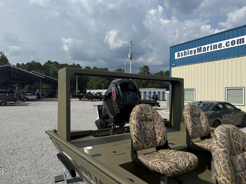 Slide: The Image of A Lowe Outlet 20-CATFISH boat with two camouflage seats and an outboard motor, parked on gravel. - 5