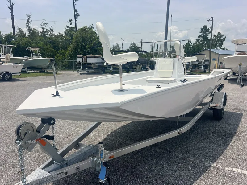 Slide: The Image of A white 2026 G3 Bay 18 boat on a trailer in an outdoor area. - 2