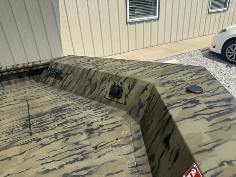 Slide: The Image of The image shows the camouflage pattern of a 2027 Lowe Roughneck 1650SC boat. - 5