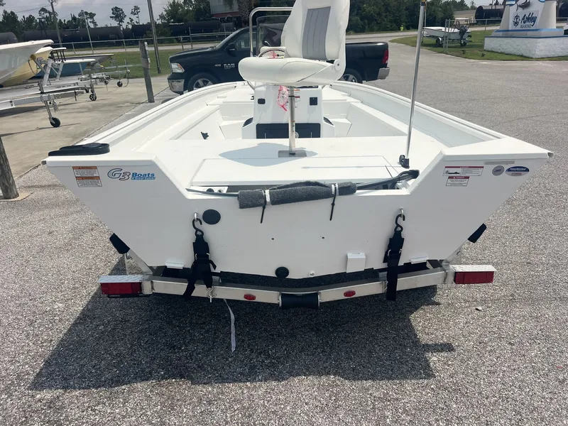 Slide: The Image of The image shows a white G3 Bay 18 boat on a trailer, ready for transport. - 6