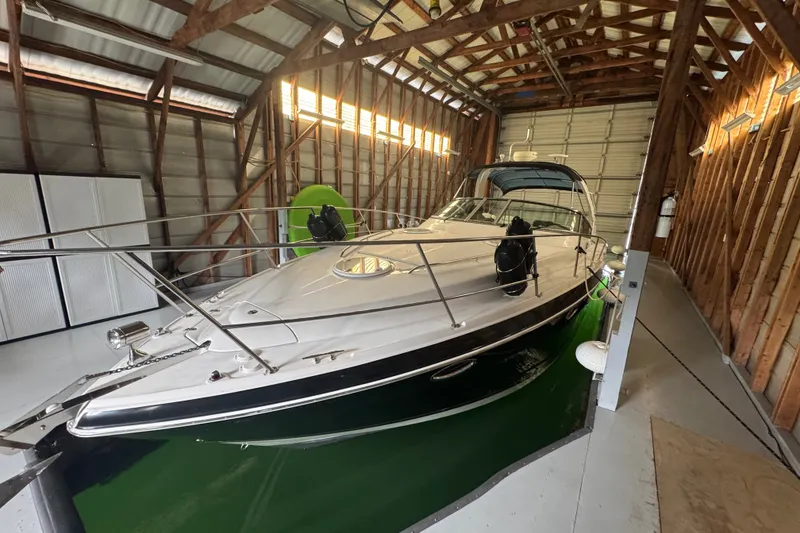 Slide: The Image of 2006 Four Winns 348 Vista boat docked in a wooden boathouse. - 2