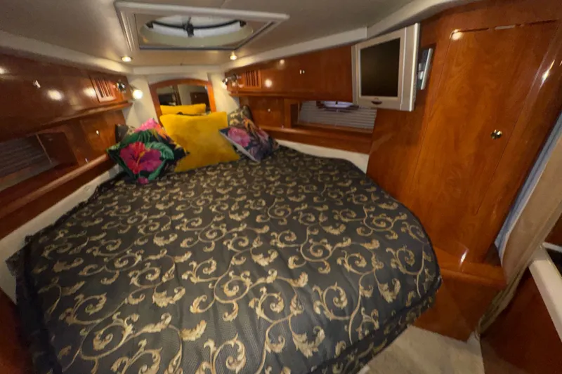 Slide: The Image of Luxurious cabin interior of 2006 Four Winns 348 Vista yacht with elegant bedding and wood finish. - 9