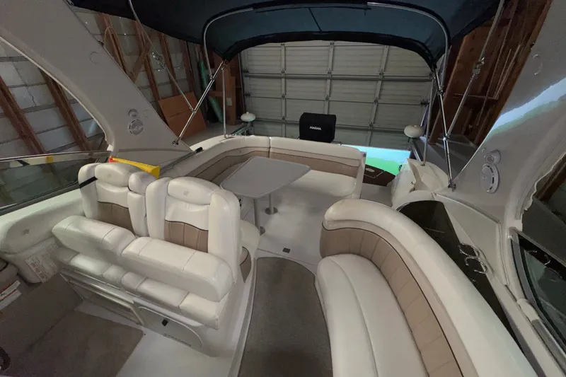 Slide: The Image of 2006 Four Winns 348 Vista boat interior with cushioned seating and table. - 12