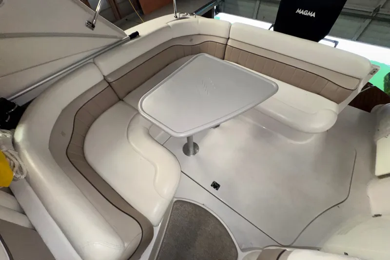 Slide: The Image of 2006 Four Winns 348 Vista boat interior with white and beige seating and table. - 19