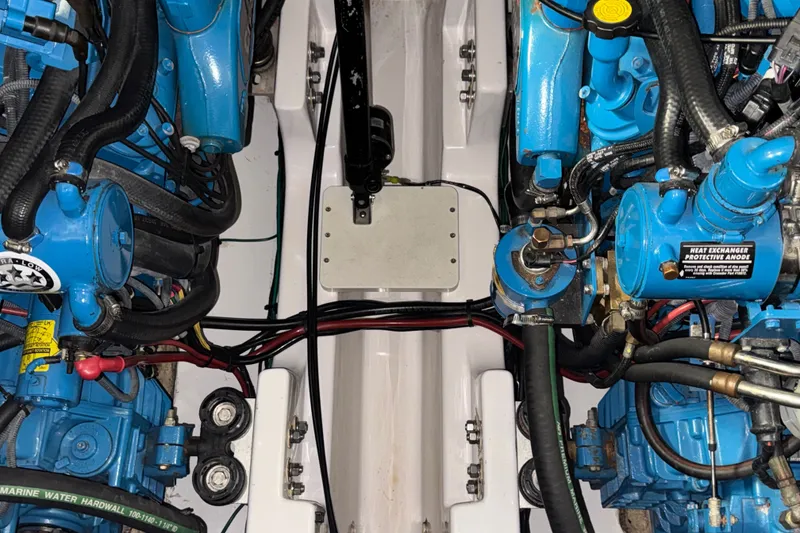 Slide: The Image of Engine compartment of a 2006 Four Winns 348 Vista boat, showcasing blue mechanical components. - 24