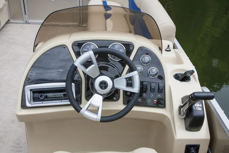 Slide: The Image of Manufacturer Provided Image: 2015 Sweetwater 2286 boat dashboard with steering wheel and control panel. - 1
