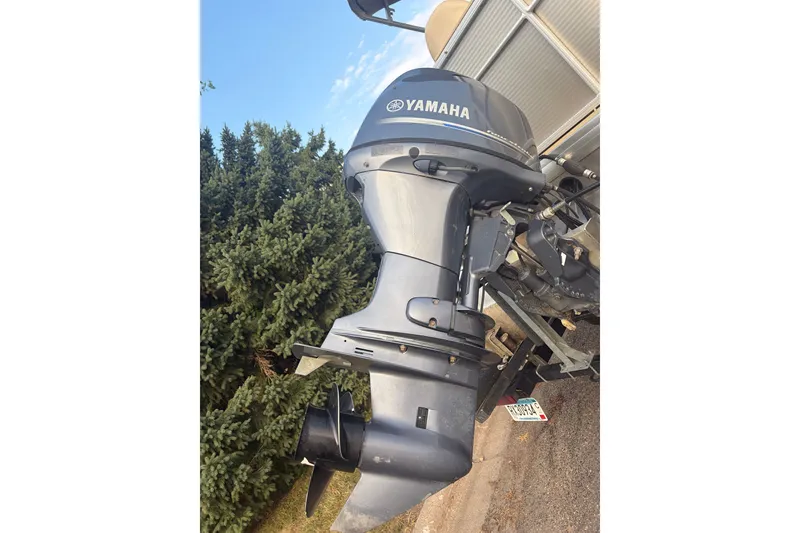 Slide: The Image of Yamaha outboard motor on a 2015 Sweetwater 2286 boat, surrounded by greenery. - 20