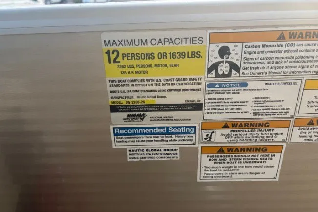 Slide: The Image of Maximum capacity label on a 2015 Sweetwater 2286 boat, detailing safety and seating guidelines. - 17