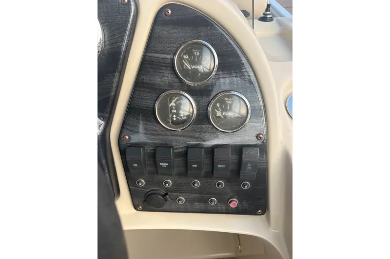 Slide: The Image of Dashboard of a 2015 Sweetwater 2286 boat with gauges and switches. - 18