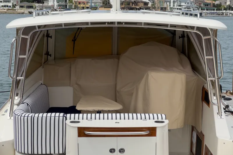 Slide: The Image of 2020 Hunt Yachts Surfhunter 32 cockpit with striped seating and covered helm. - 61