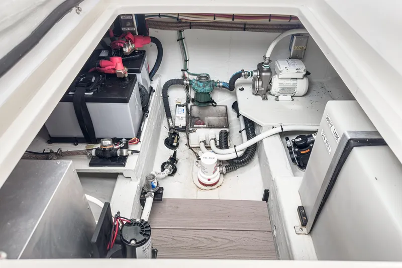Slide: The Image of Engine compartment of 2020 Hunt Yachts Surfhunter 32, showcasing batteries and mechanical systems. - 63