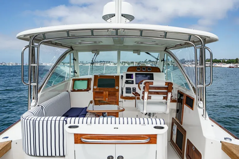 Slide: The Image of 2020 Hunt Yachts Surfhunter 32 interior with striped seating and navigational equipment. - 30