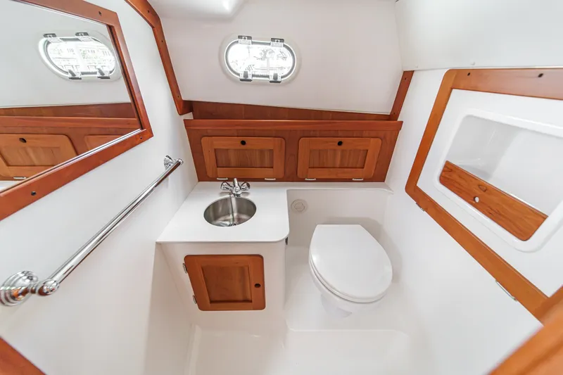 Slide: The Image of Luxurious 2020 Hunt Yachts Surfhunter 32 bathroom with wood accents and stainless steel fixtures. - 56