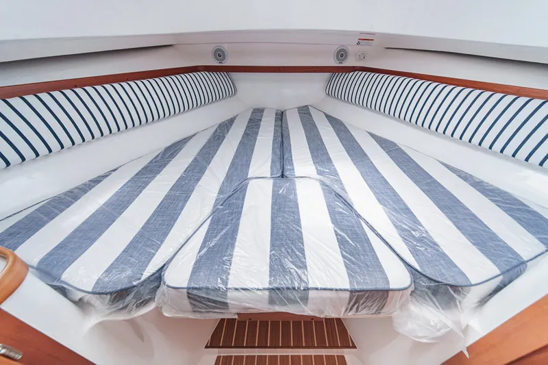 Slide: The Image of 2020 Hunt Yachts Surfhunter 32 cabin with striped bedding and wooden accents. - 51