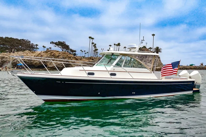The Image of 2020 Hunt Yachts Surfhunter 32 in scenic coastal waters with American flag. - 0