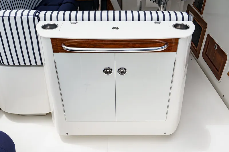 Slide: The Image of Interior of 2020 Hunt Yachts Surfhunter 32 with striped seating and storage cabinet. - 25