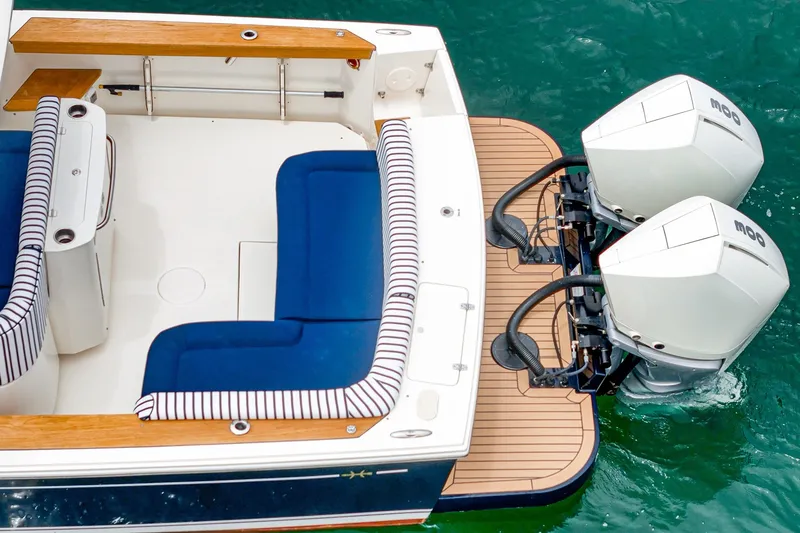 Slide: The Image of 2020 Hunt Yachts Surfhunter 32 with twin outboard engines and blue seating. - 58