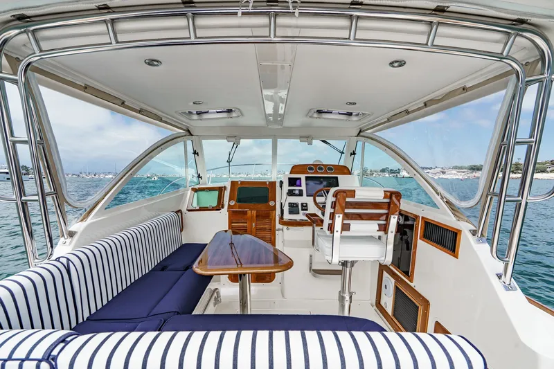 Slide: The Image of Interior of 2020 Hunt Yachts Surfhunter 32 with striped seating and helm view. - 31