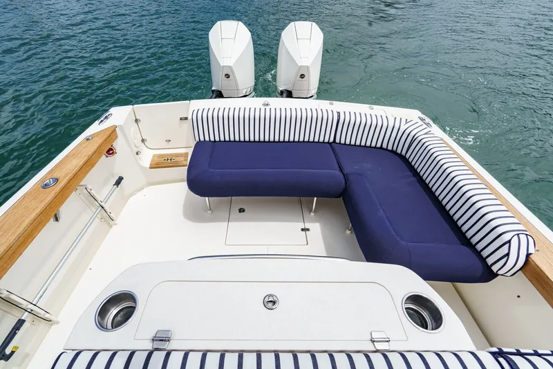 Slide: The Image of 2020 Hunt Yachts Surfhunter 32 with striped seating and twin engines on water. - 19