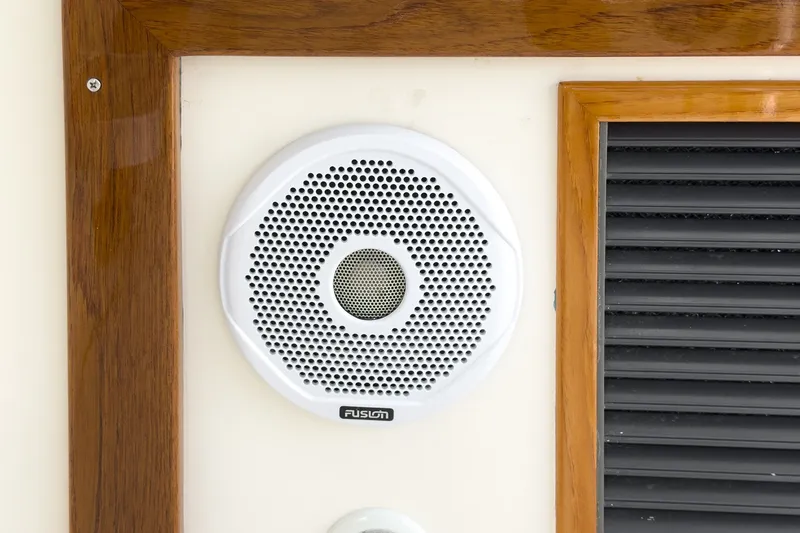 Slide: The Image of White Fusion speaker on 2020 Hunt Yachts Surfhunter 32, framed by wood paneling. - 42