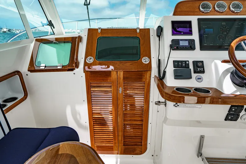 Slide: The Image of 2020 Hunt Yachts Surfhunter 32 cockpit with polished wood finish and modern controls. - 43