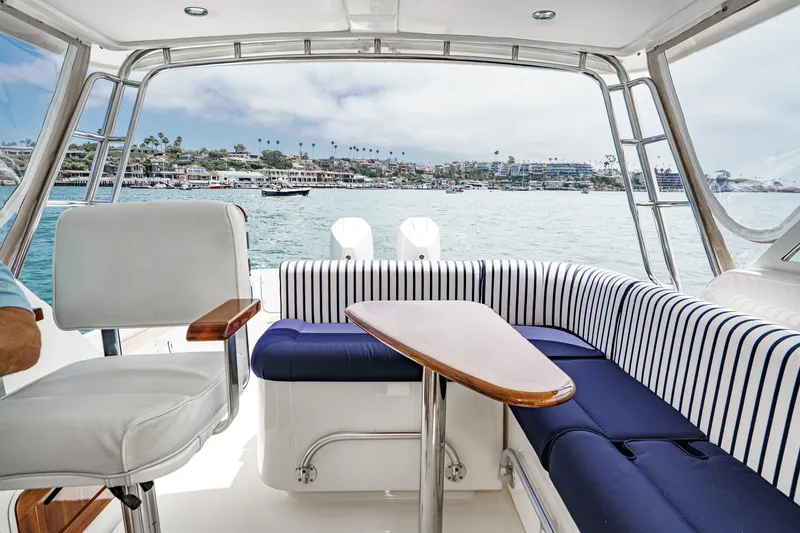 Slide: The Image of Interior view of 2020 Hunt Yachts Surfhunter 32 with striped seating and ocean backdrop. - 45
