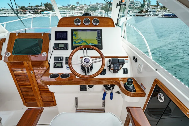 Slide: The Image of Helm of 2020 Hunt Yachts Surfhunter 32 with navigation equipment and wooden accents. - 35
