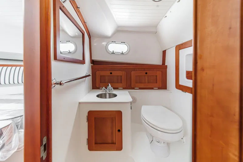 Slide: The Image of 2020 Hunt Yachts Surfhunter 32 bathroom with wooden cabinetry and compact design. - 55