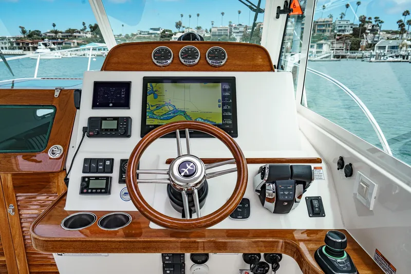 Slide: The Image of Helm of 2020 Hunt Yachts Surfhunter 32 with navigation controls and wooden accents. - 37