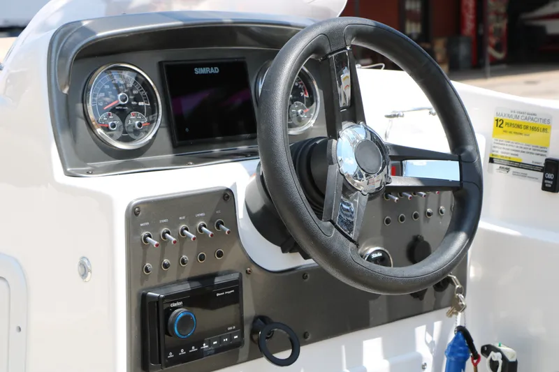 Slide: The Image of Steering console of 2022 Hurricane SunDeck Sport 201 IO boat with gauges and controls. - 34