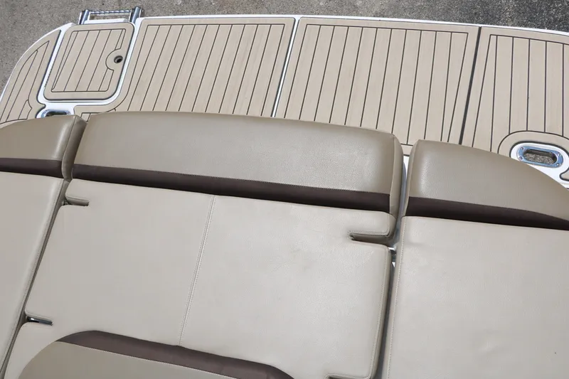 Slide: The Image of 2022 Hurricane SunDeck Sport 201 IO boat seating and deck, featuring tan upholstery and wood-like flooring. - 30