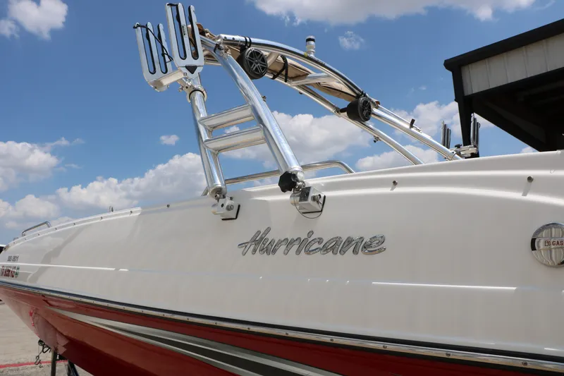 Slide: The Image of 2022 Hurricane SunDeck Sport 201 IO boat with sleek design under a blue sky. - 6