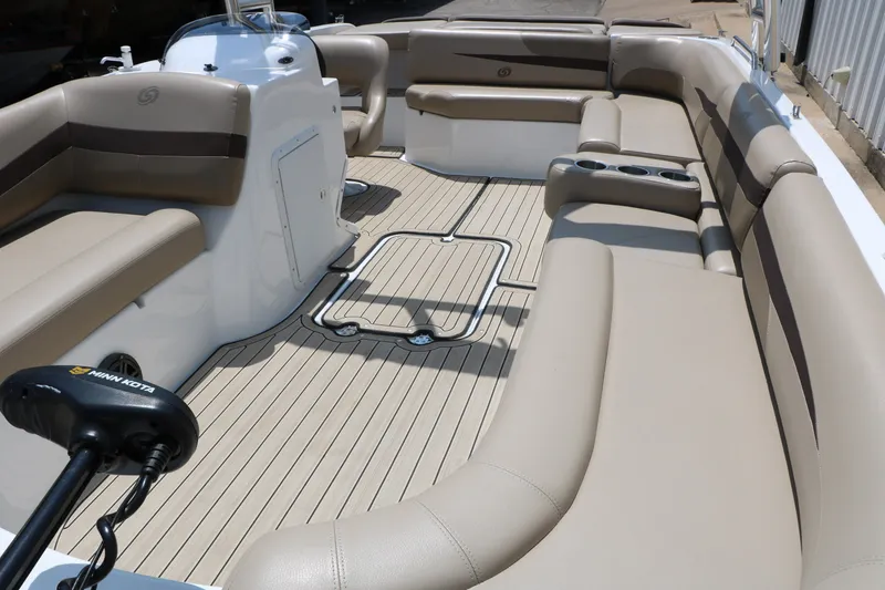 Slide: The Image of 2022 Hurricane SunDeck Sport 201 IO boat interior with beige seating and Minn Kota motor. - 22