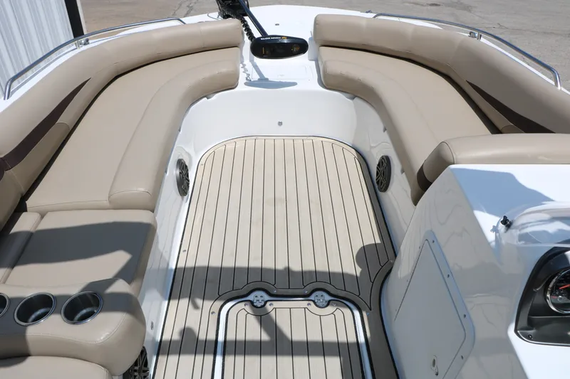 Slide: The Image of 2022 Hurricane SunDeck Sport 201 IO boat interior with beige seating and wood-style flooring. - 17