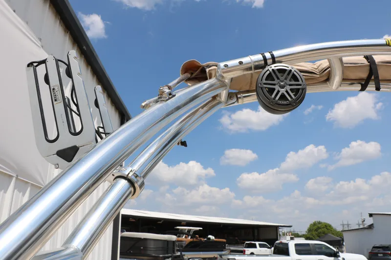 Slide: The Image of 2022 Hurricane SunDeck Sport 201 IO boat tower with speaker, under a clear blue sky. - 32