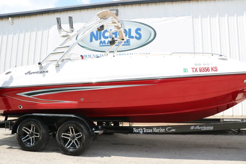 Slide: The Image of 2022 Hurricane SunDeck Sport 201 IO boat with red hull on trailer at North Texas Marine. - 7