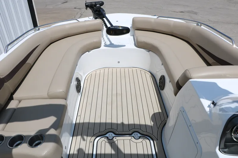 Slide: The Image of 2022 Hurricane SunDeck Sport 201 IO boat interior with beige seating and wood-style flooring. - 16