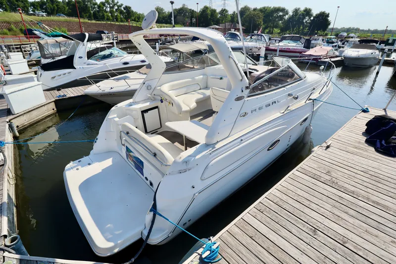 The Image of A white 2003 Regal Commodore 2860 docked, surrounded by other boats. - 0