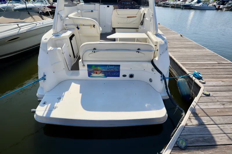 Slide: The Image of Rear view of a 2003 Regal Commodore 2860 docked at a wooden pier. - 4