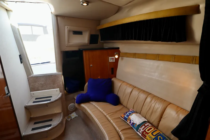 Slide: The Image of Interior of a 2003 Regal Commodore 2860 with beige sofa and blue cushions. - 17