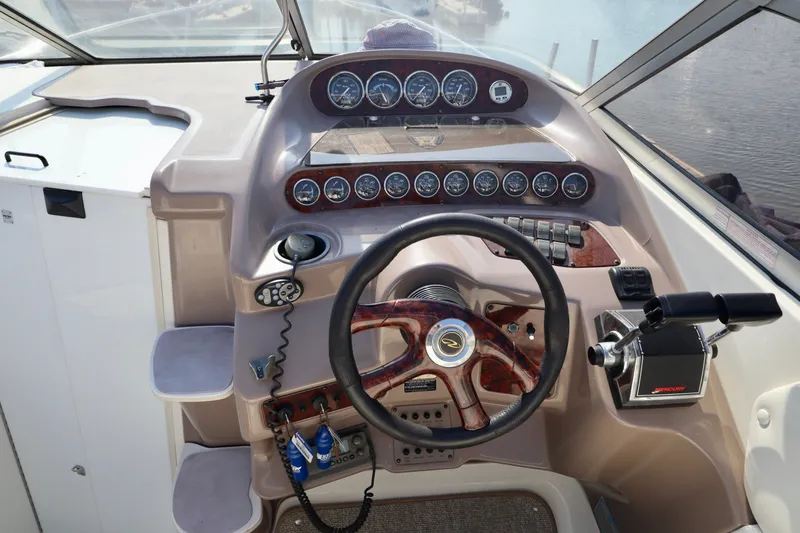 Slide: The Image of The image shows the helm of a 2003 Regal Commodore 2860 with a wood steering wheel and instruments. - 3