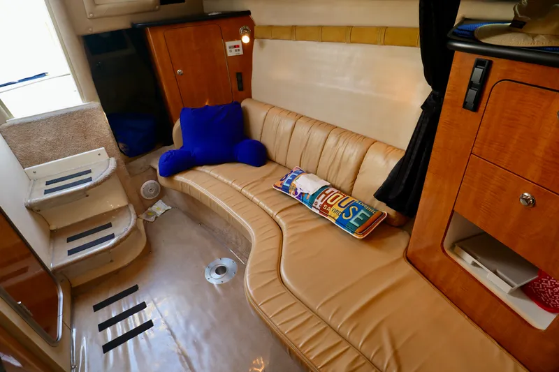 Slide: The Image of Interior of a 2003 Regal Commodore 2860 with beige leather sofa and wooden cabinetry. - 16