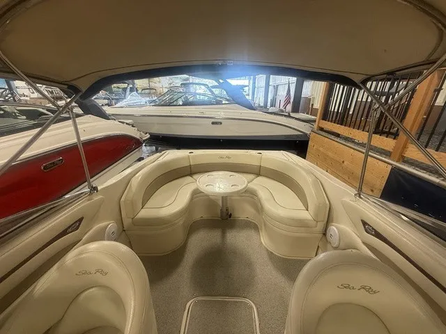 Slide: The Image of The image shows the cockpit of a 2001 Sea Ray 260 Signature boat with beige seating. - 17
