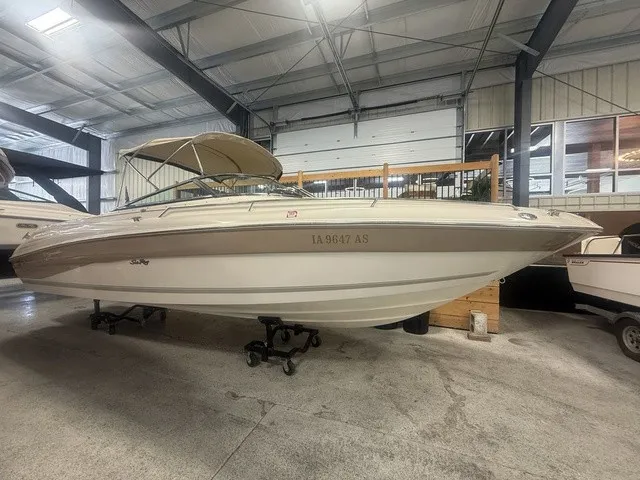 Slide: The Image of A 2001 Sea Ray 260 Signature is indoors. It features a beige canopy. - 2