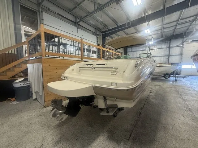 Slide: The Image of A 2001 Sea Ray 260 Signature is in a storage facility. The boat features an outboard motor. - 5