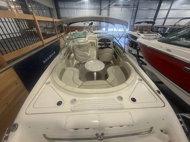 Slide: The Image of The image shows a 2001 Sea Ray 260 Signature boat in a warehouse. - 3