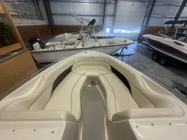 Slide: The Image of The image shows the bow area of a 2001 Sea Ray 260 Signature boat with beige upholstery. - 16