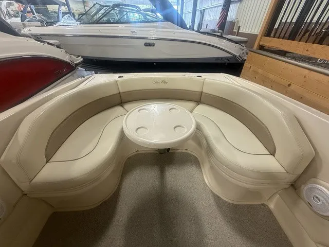 Slide: The Image of Interior of a 2001 Sea Ray 260 Signature with cream-colored seating and a round table. - 14