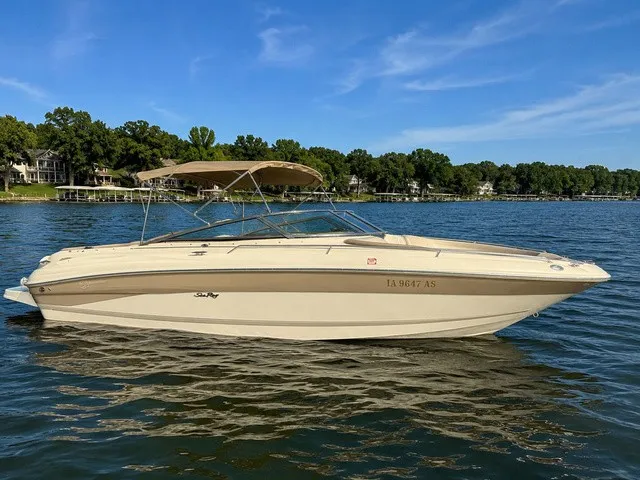The Image of A 2001 Sea Ray 260 Signature on a calm lake with trees in the background. - 1