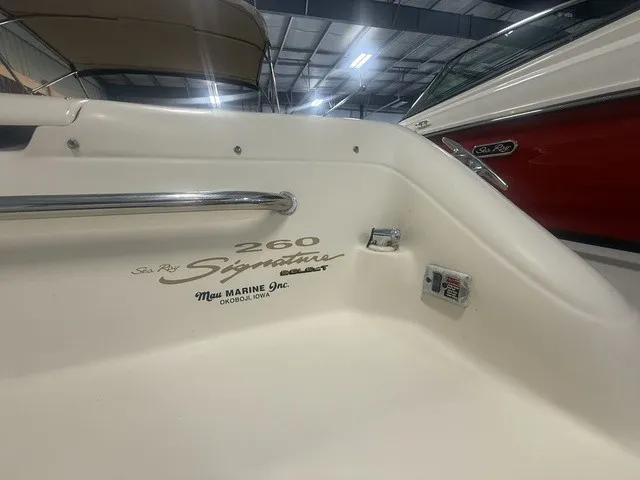 Slide: The Image of Interior view of a 2001 Sea Ray 260 Signature boat with branding and controls visible. - 13